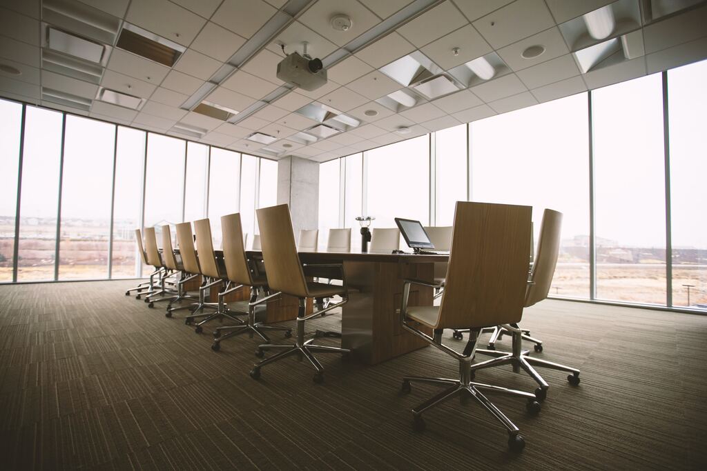 A spacious boardroom set up for a meeting, symbolizing efficient board report preparation.